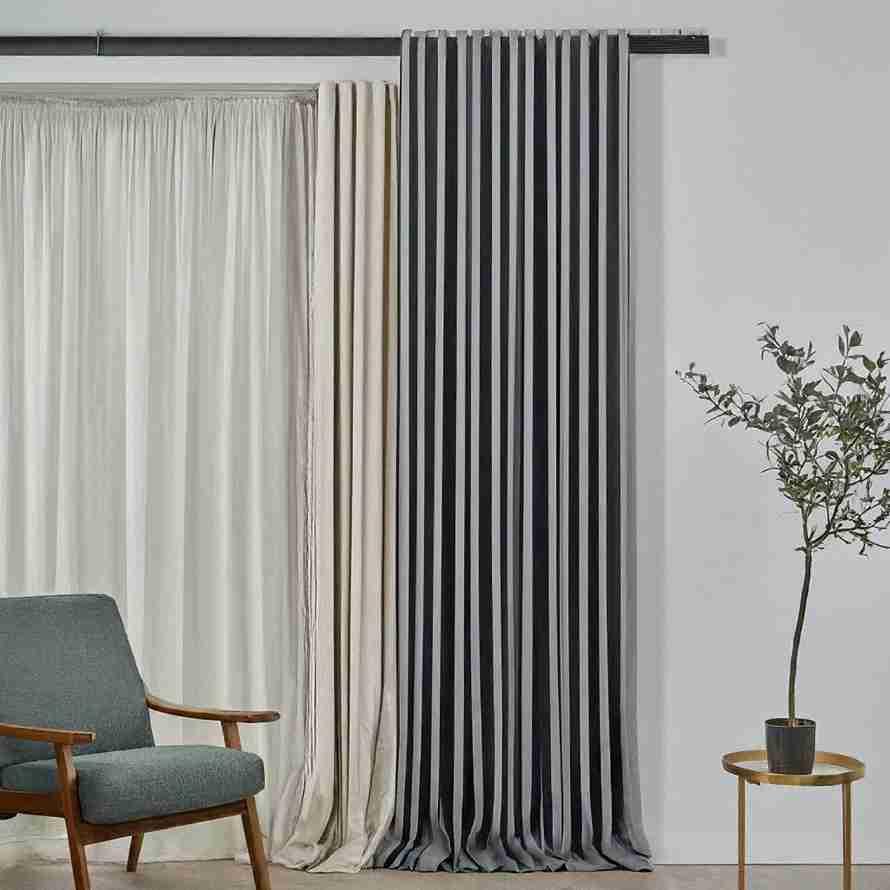 A chair positioned near window curtains for bedroom, enhancing the room's comfort and aesthetic appeal.